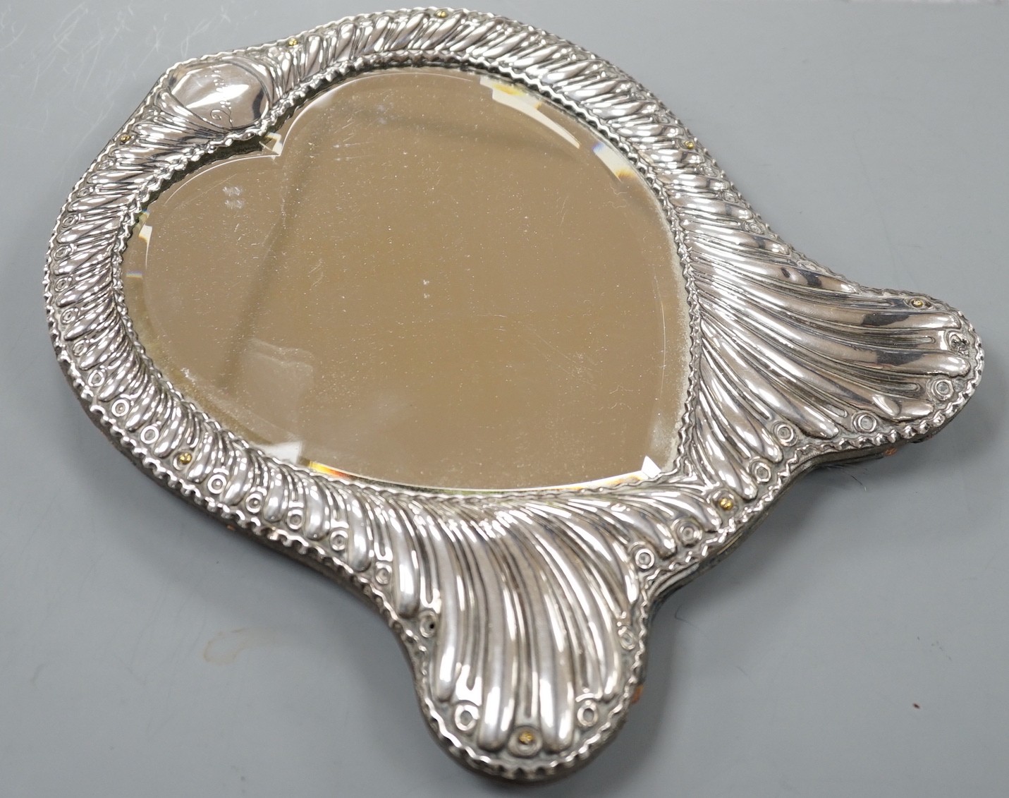 A late Victorian repousse silver mounted heart shape easel mirror, William Comyns, London, 1900, 26.5cm.